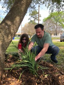 Father-daughter team working on oak tree bed