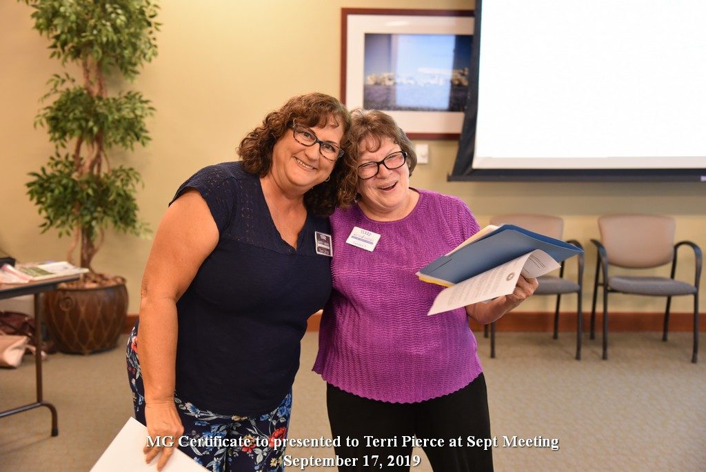 Brenda Posh receives MG certificate from Carolyn