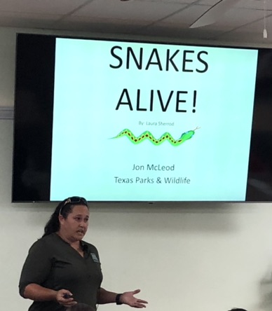 Volunteer Laura Sherrod teaches campers about Texas snakes