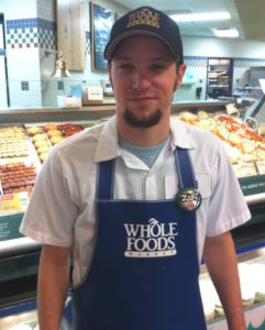 Boy with whole foods apron