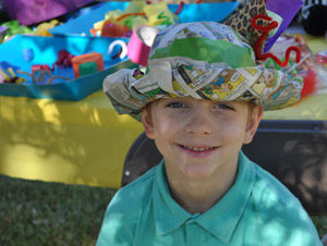 boy wearing paper hat